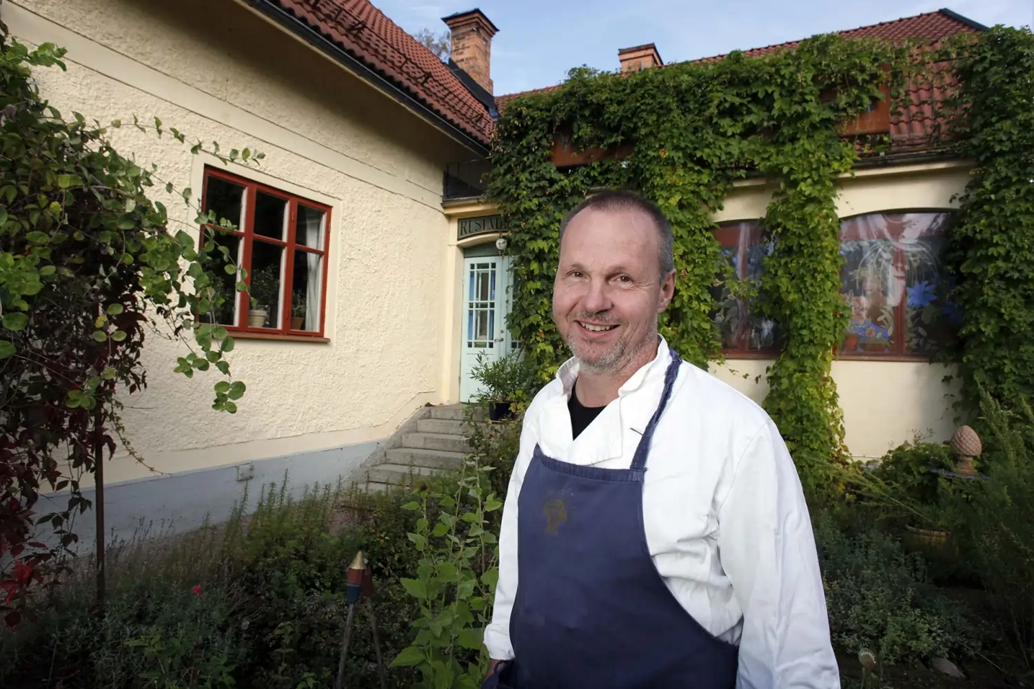 A happy person who is standing in front of a house